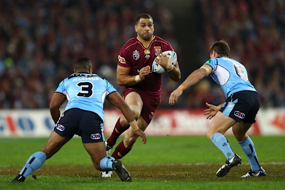 Greg Inglis of the Maroons is tackled.