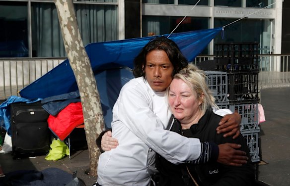 a homeless couple embraces in concern before evacuating Tent City at Martin Place on August 11, 2017 in Sydney, Australia. (Photo by Daniel Munoz/Fairfax Media)