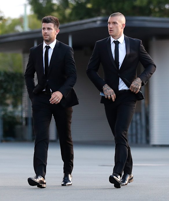 Trent Cotchin of the Tigers (left) and teammate Dustin Martin arrive at Metricon Stadium.