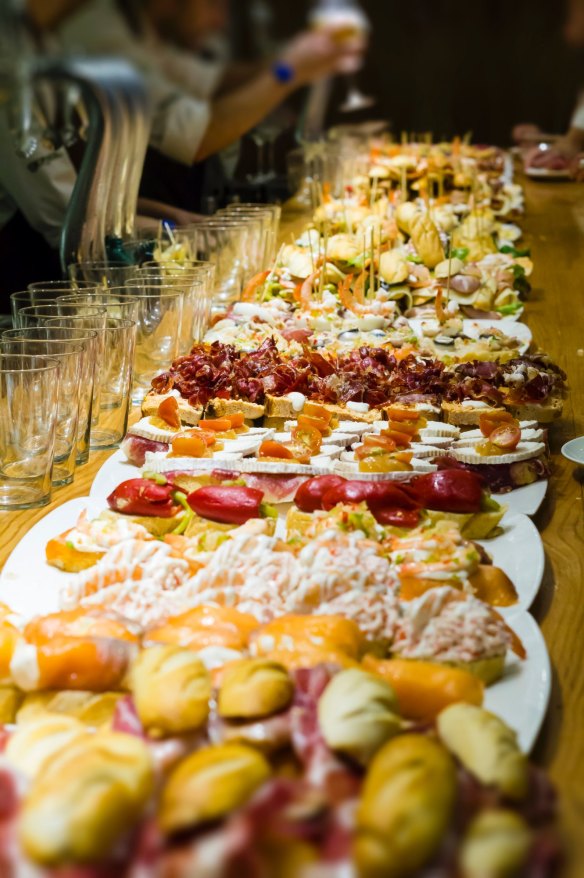 Spanish pintxos on the counter of the tapas bar in the gastronimical capital of Spain - San Sebastian. 