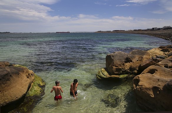 Crowds find refuge from the oppressive heat, swimming at Yarra Bay.