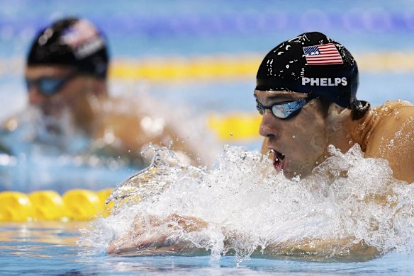 Michael Phelps of the US swims to win gold in the men's 200m individual medley final, next to compatriot Ryan Lochte.