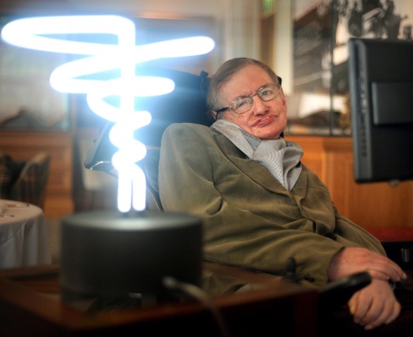 Professor Stephen Hawking poses beside a lamp titled ‘Black Hole Light’ at the Science Museum in London in 2012. 