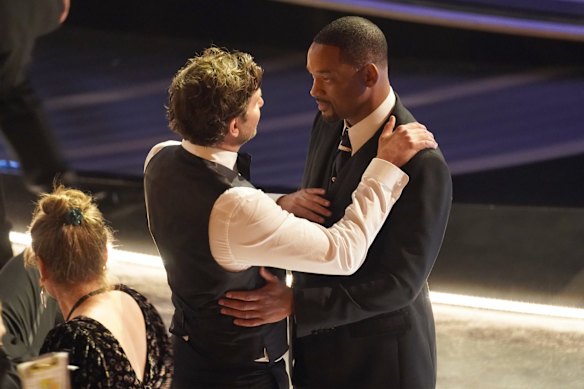 Bradley Cooper, left, and Will Smith appear in the audience.