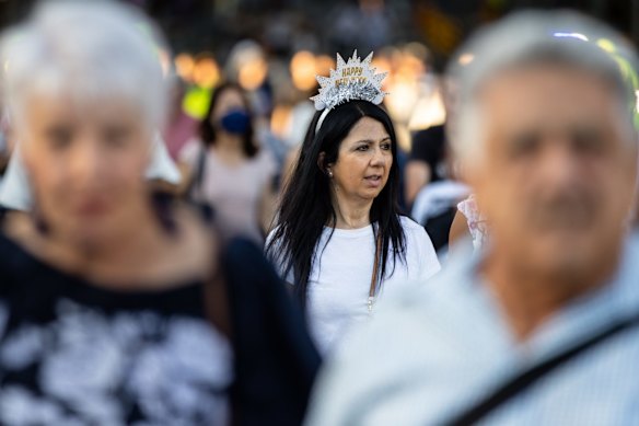 People walk along Princes Bridge during New Years Eve celebrations in Melbourne'