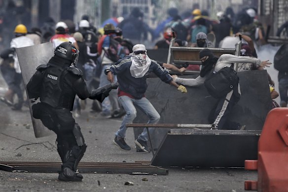 Demonstrators clash with the police during an anti-government protest in Cali, Colombia as the county marks its Independence Day. 