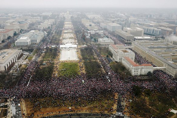 With the U.S. Capitol in the background, and Independence Avenue along the right side, a crowd overflows onto the National Mall during the Women's March on Washington during the first full day of Donald Trump's presidency.