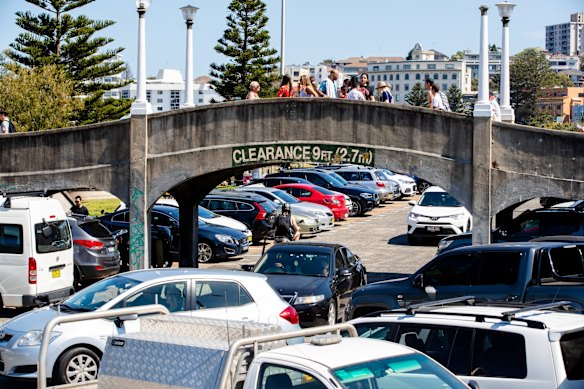 People enjoying the long weekend at Bondi Beach, the carpark busy but not closed.