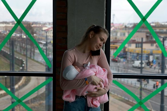 Irina Szymanska holds her baby in a temporary shelter at the central train station for displaced people heading to Poland in Lviv. Szymanska fled her hometown of Pavlograd with her family before the possibility of renewed military action in Ukraine's east.