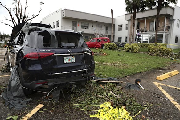 Cars damaged from an apparent overnight tornado spawned from Hurricane Ian at Kings Point 55+ community in Delray Beach, Fla.,  on Wednesday, Sept. 28, 2022.   (Carline Jean/South Florida Sun-Sentinel via AP)
