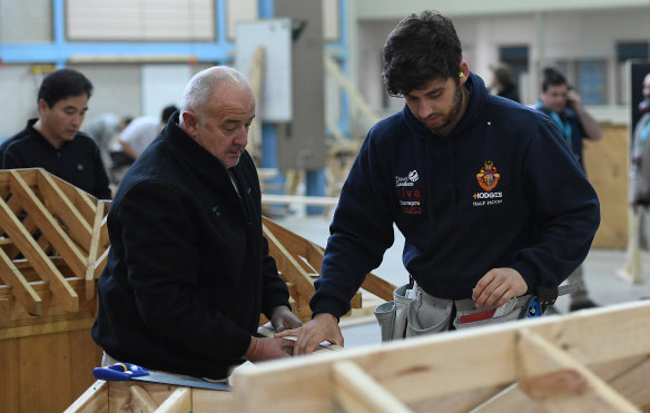 A master and apprentice carpenter are seen at Holmesglen TAFE Chadstone campus in 2017. 