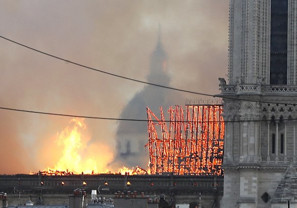 Flames rise from Notre Dame cathedral as it burns in Paris.