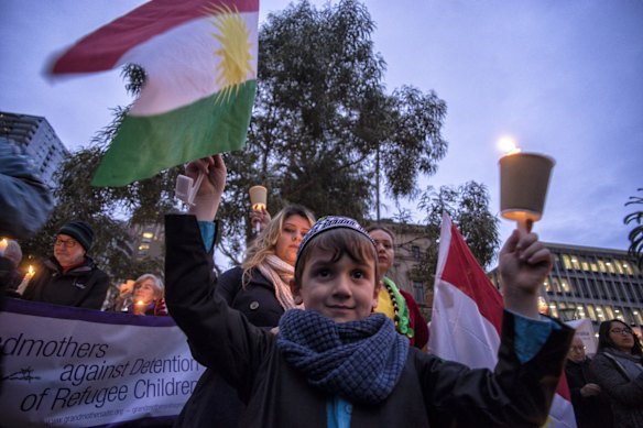 People are seen at the Light The Dark: Melbourne says Welcome candlelight vigil for refugees at Treasury Gardens