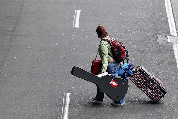 A passenger leaves the Qantas Domestic Terminal in Sydney.