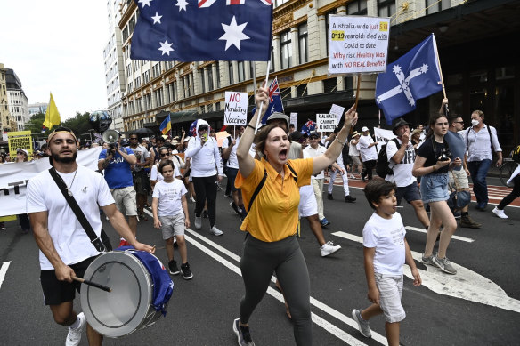 Children were among a large crowd protesting on Saturday against vaccine mandates and the cancellation of tennis player Novak Djokovic’s visa.