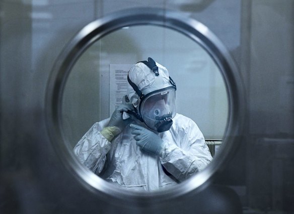 Associate Professor Stuart Turville, a virologist at the Kirby Institute and working temporarily at St Vincent's Centre for Applied Medical Research, donning on PPE before analysing antibody reaction with the COVID-19 Omicron variant.