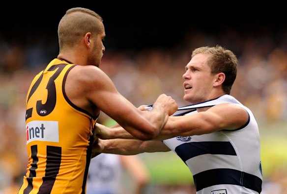 Hawthorn's Lance Franklin disagrees with Joel Selwood.
