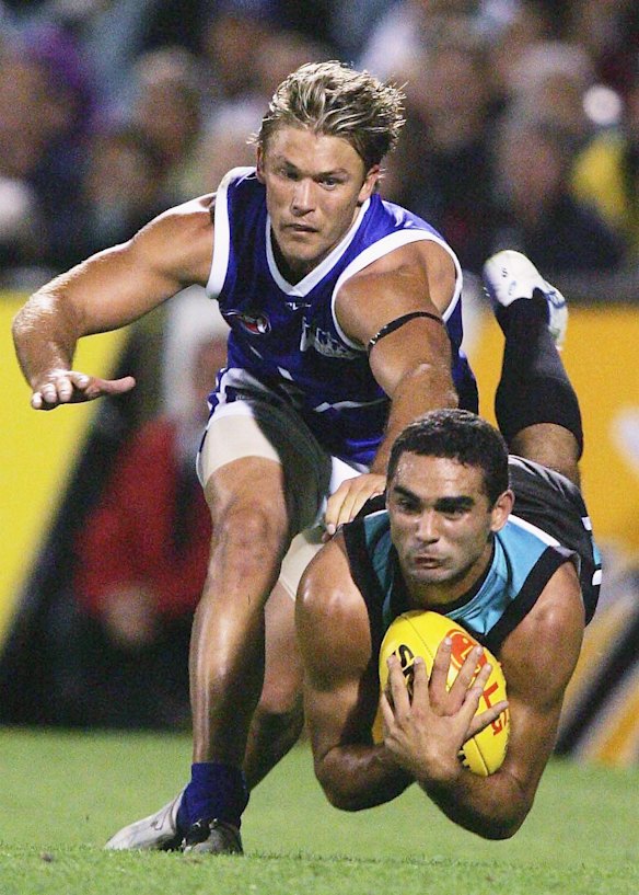 2006 Shaun Burgoyne of Port and Jess Sinclair of Kangaroos in action during the round one AFL match between Port Adelaide and the Kangaroos.
