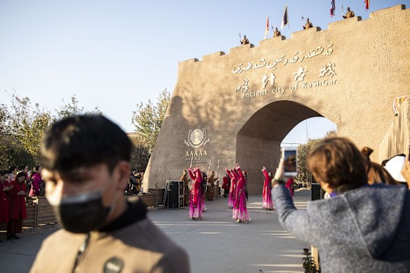 Dancers perform in front of a gate to the Old City in Kashgar, Xinjiang autonomous region, China.