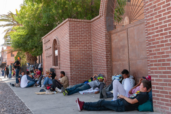 Migrants seek refuge outside Sacred Heart Church in El Paso, Texas, on the day Title 42 expired.