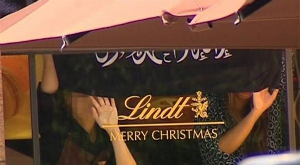 Hostages were earlier seen against the window of the Lindt Chocolat Cafe in Martin Place.