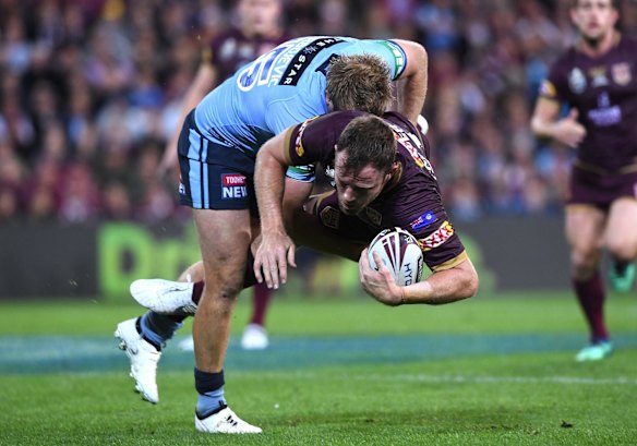 Jake Trbojevic of the Blues tackles Gavin Cooper of the Maroons.