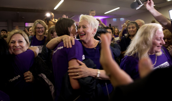 Independent candidate for Wentworth Kerryn Phelps (centre) is congratulated by supporters as she arrives for a Wentworth by-election evening function at North Bondi Life Saving Club.
