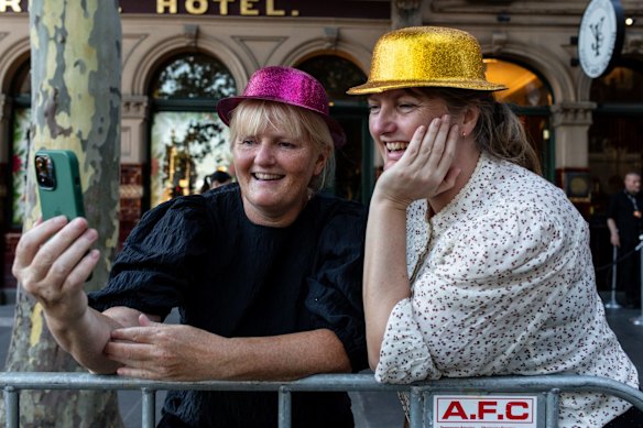 People are seen taking a selfie during New Year's Eve celebrations in Melbourne.