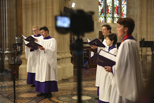 Members of the St Andrews Cathedral choir perform in front of cameras and microphones on site at the Cathedral in a recording of their Christmas service which will be now be an online event due to the recent restrictions relating to the COVID-19 Pandemic and the latest recent Northern Beaches cluster.