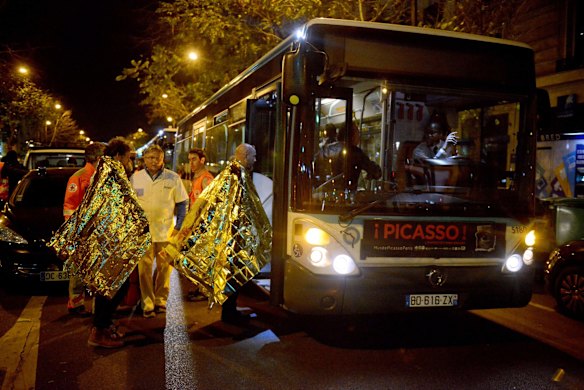 Survivors board a bus after surviving the gunfire at the Bataclan concert hall.