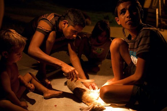 Preparing a rabbit for cooking, which was caught in the surrounding bushland.