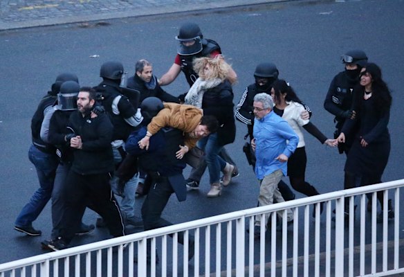 Police escort hostages out of the siege. 