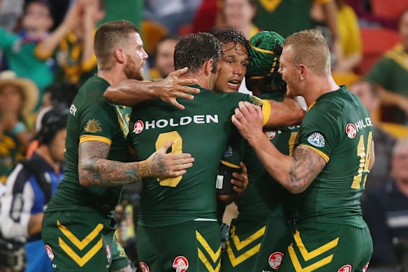 Will Chambers, centre, is congratulated after scoring for the Kangaroos. 