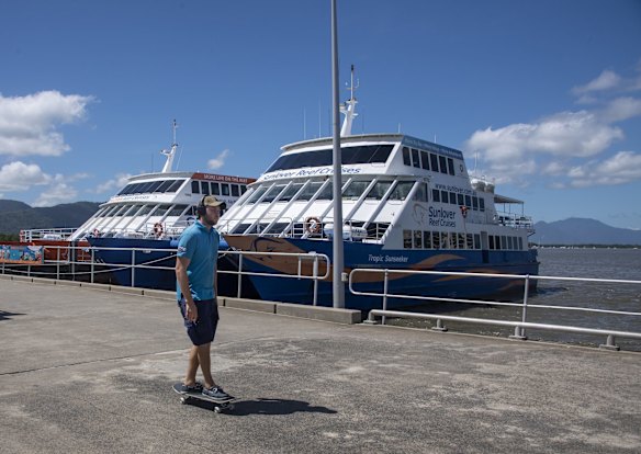 The vessels Great Barrier Reef tourist boat fleet moored at the Marlin Jetty. At this time of year, they would normally be all out at sea but now sit idle and empty each day. 
