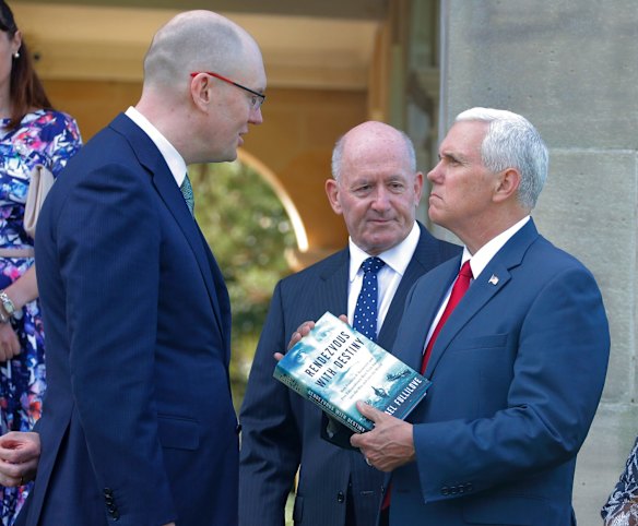 U.S. Vice President Mike Pence receives the gift of a book called "Rendezvous with Destiny" from author Michael Fullilove (L) alongside Australian Governor General Peter Cosgrove.