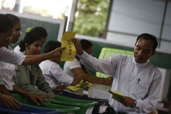 Officials of Union Election Commission sort ballots at a polling station in Mandalay, Myanmar.
