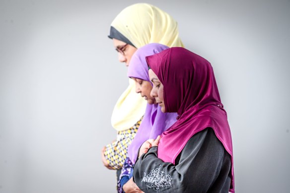 Muslim women Mai Shouman, Meherun Nisa and Rita Joyan pray at Gungahlin Mosque on Saturday afternoon, after terror attacks at mosques in New Zealand on Friday.