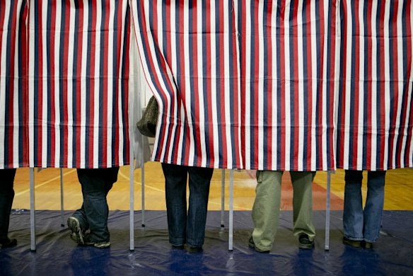 Voters fill out ballots at a polling station in New Hampshire on Election Day 2012