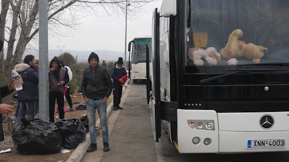More waiting alongside buses. 