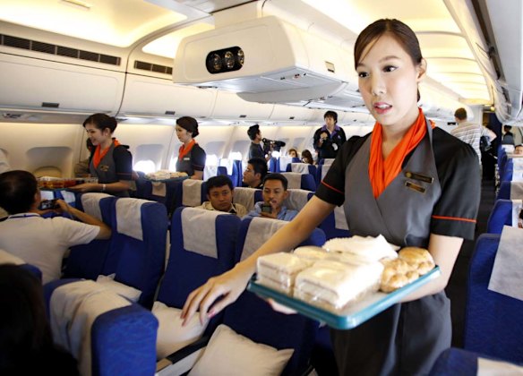 PC Air transsexual flight attendant Chayathisa Nakmai, 24, serves passengers.