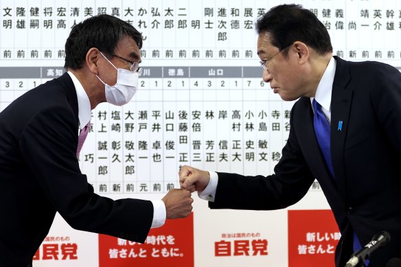 Japan’s former foreign minister and senior member of the Liberal Democratic Party Taro Kono (left) fist bumps with Prime Minister and party leader Fumio Kishida at party headquarters.