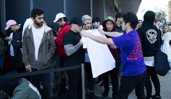 Kanye West fans line up for the opening of his pop up clothing store in Bondi.