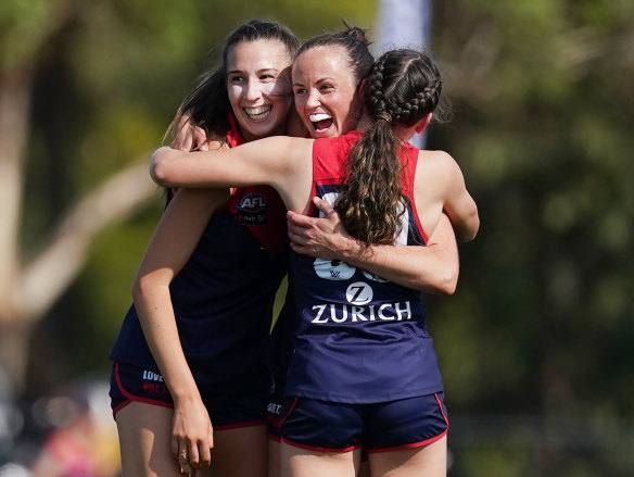 That winning feeling: Daisy Pearce and teammates.