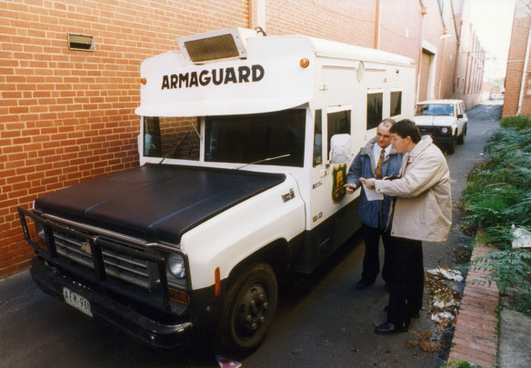 Police examine the Armaguard van after it was abandoned in the armed robbery in 1994.