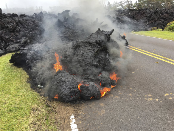 Lava from the Kilauea volcano moves across the road in the Leilani Estates in Pahoa, Hawaii, on May 5.