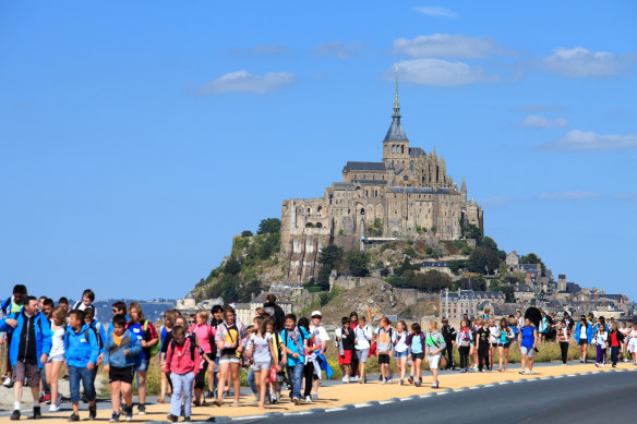 Tourists swamp Mont Saint-Michel.