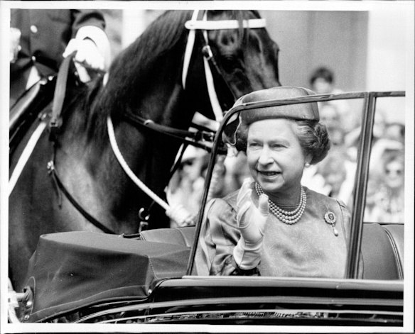 The Queen and Prince Philip transfer to an open car in Macquarie Street for their short drive to the Palace Gardens.