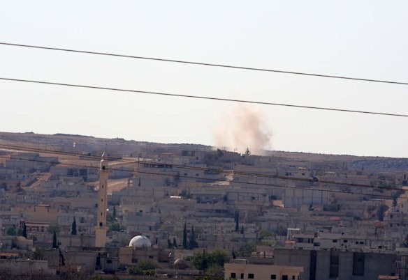 A mortar shelling lands as fighting intensified between Syrian Kurds and the militants of Islamic State in Kobani in Syria, in the background, in Mursitpinar near Suruc, Turkey, Saturday, Oct. 4, 2014. Photo by AP