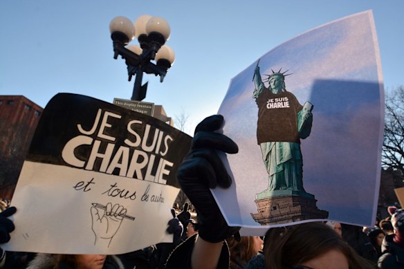 People attend a rally Saturday, Jan. 10, 2015, at Washington Square Park, in New York in support of free expression and those killed following three days of violence in France.