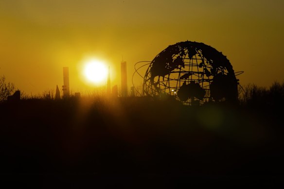 The sun sets behind the Unisphere in Flushing Meadows Corona Park, Saturday, April 11, 2020, in the Queens borough of New York.